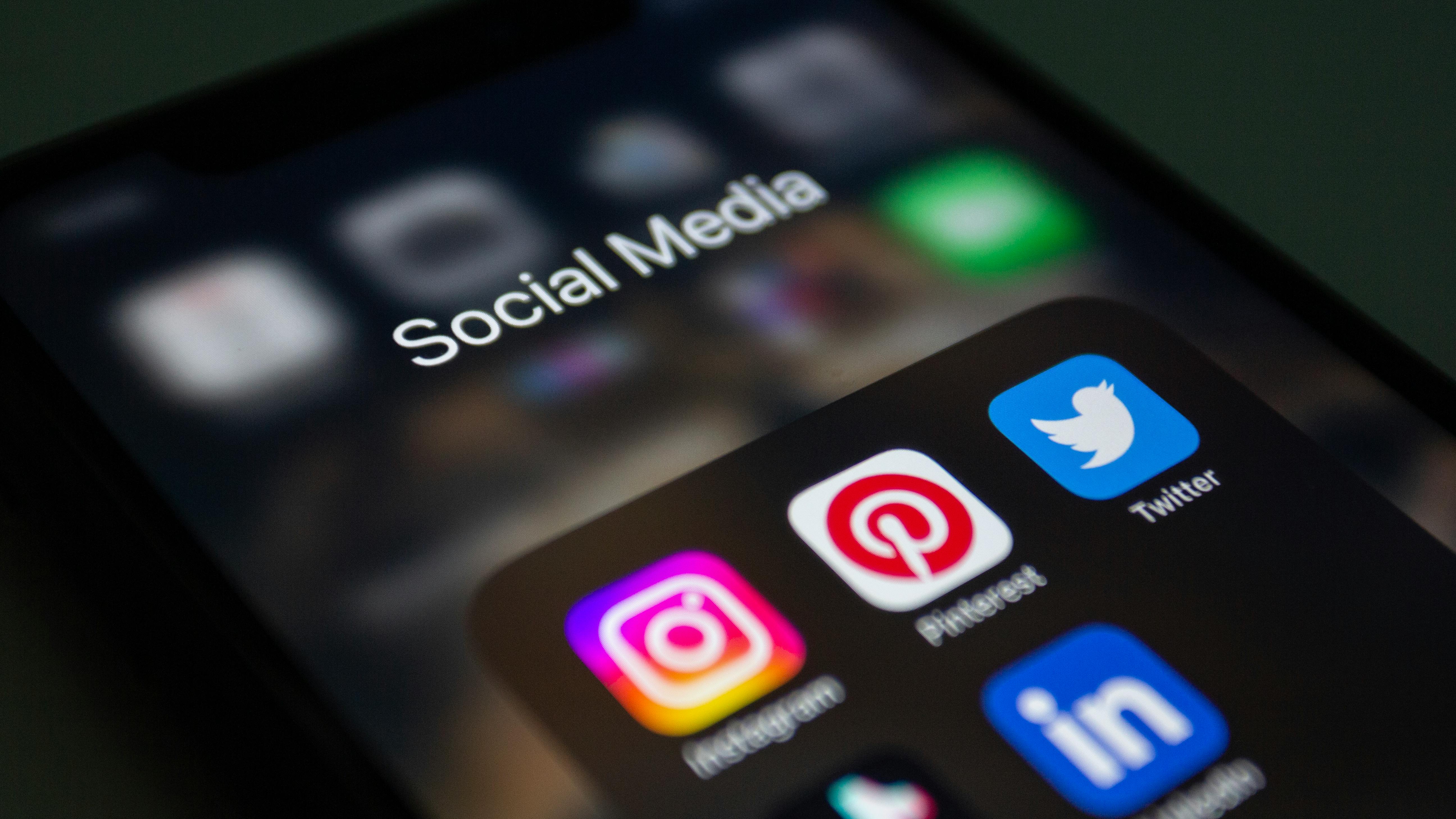 Person working with social media content strategy on a mobile-first workspace.